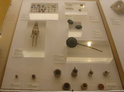 A display of Roman toys, including several that would be familiar to children today: a doll, dice, rattles, and toy dishes for playing house.
